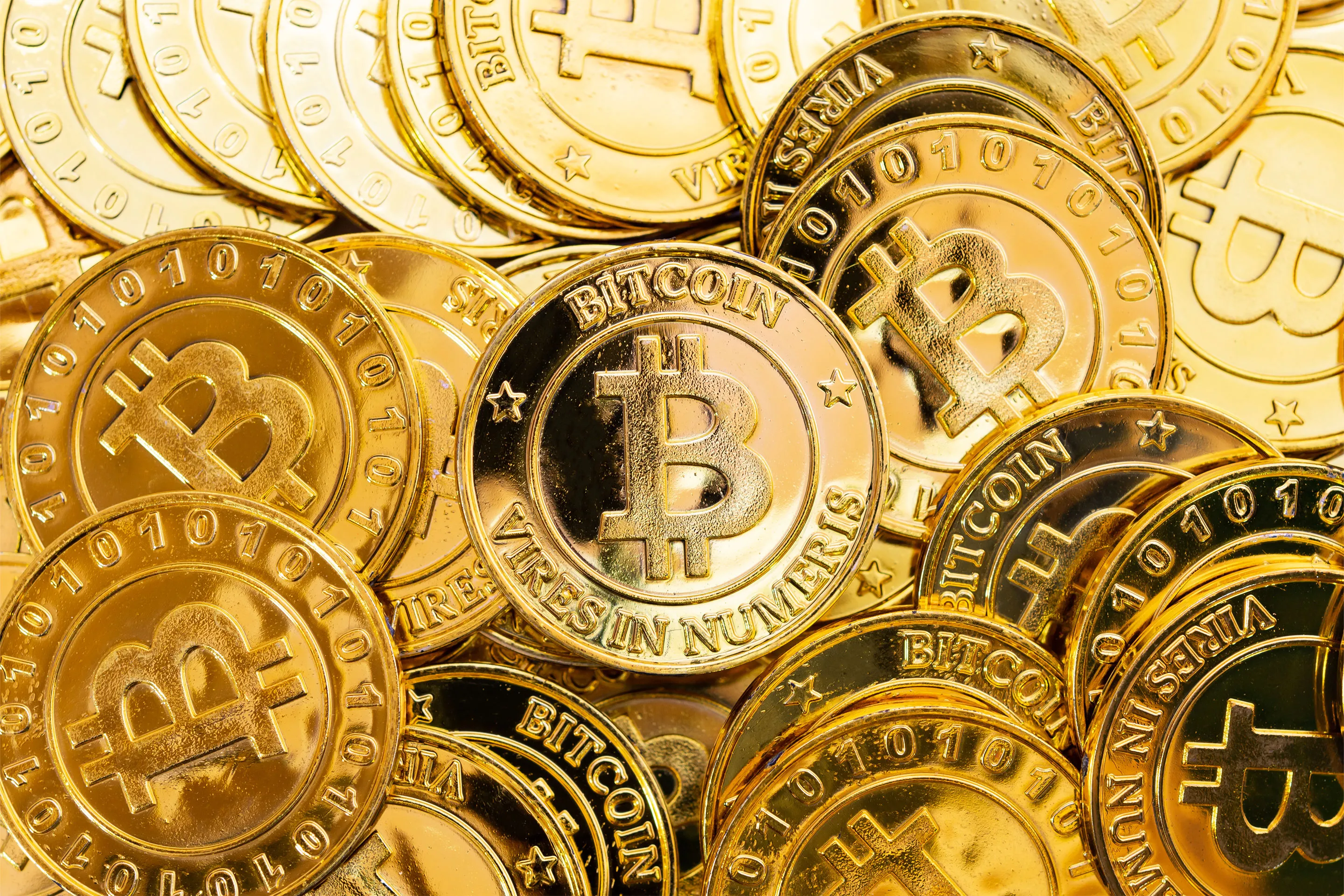 Gold, bitcoin pull back from records as US stock markets slip